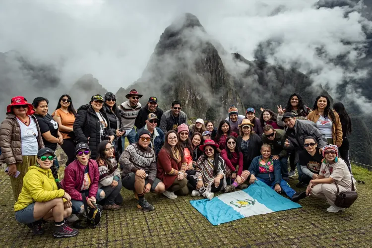 Travelers on a guided visit overlooking the Machu Picchu citadel